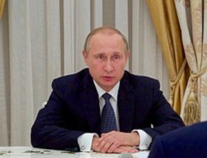 Putin sitting at a table