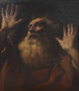 Picture of a man looking up and holding his hands up