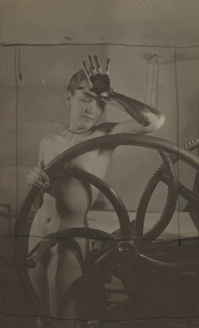 A nude woman behind a wheel